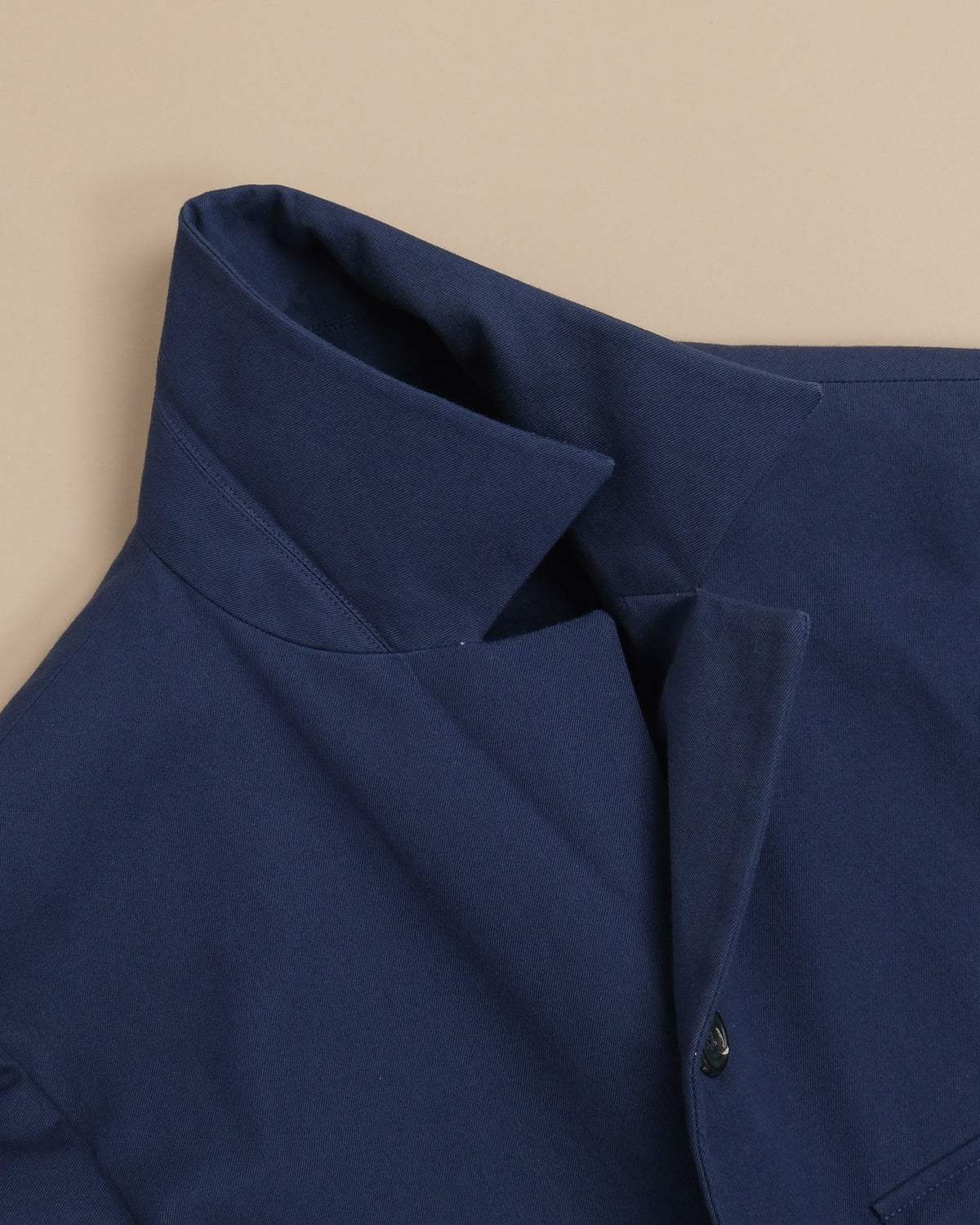 Detail of the tall collar on the Navy Cotton Twill Safari Jacket by Cad & The Dandy. 