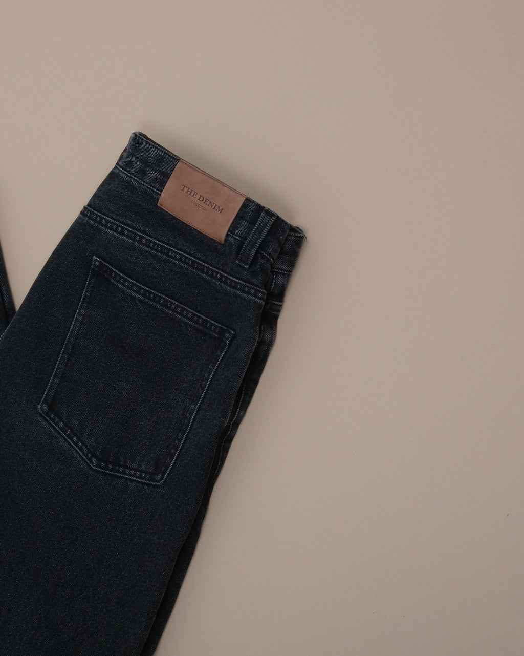 Detail of tag on Faded Black Wash High-Rise Jeans by Grand Le Mar
