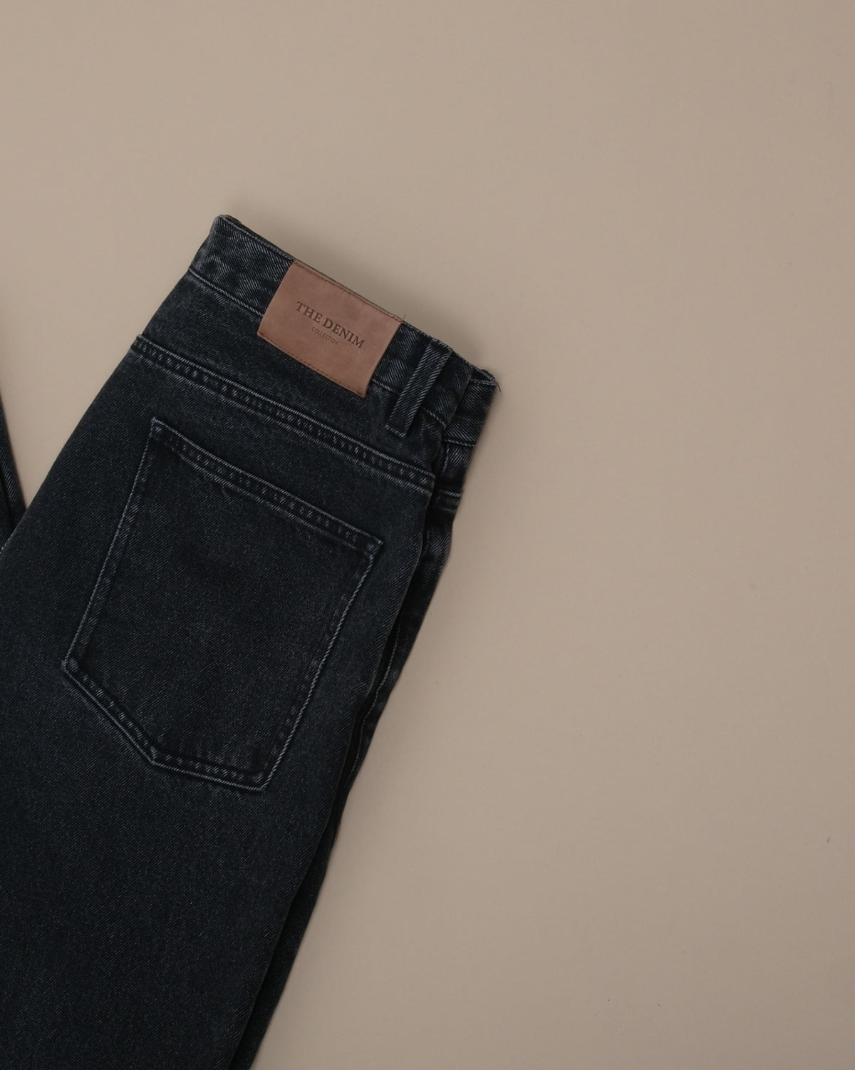 Detail of tag on Faded Black Wash High-Rise Jeans by Grand Le Mar