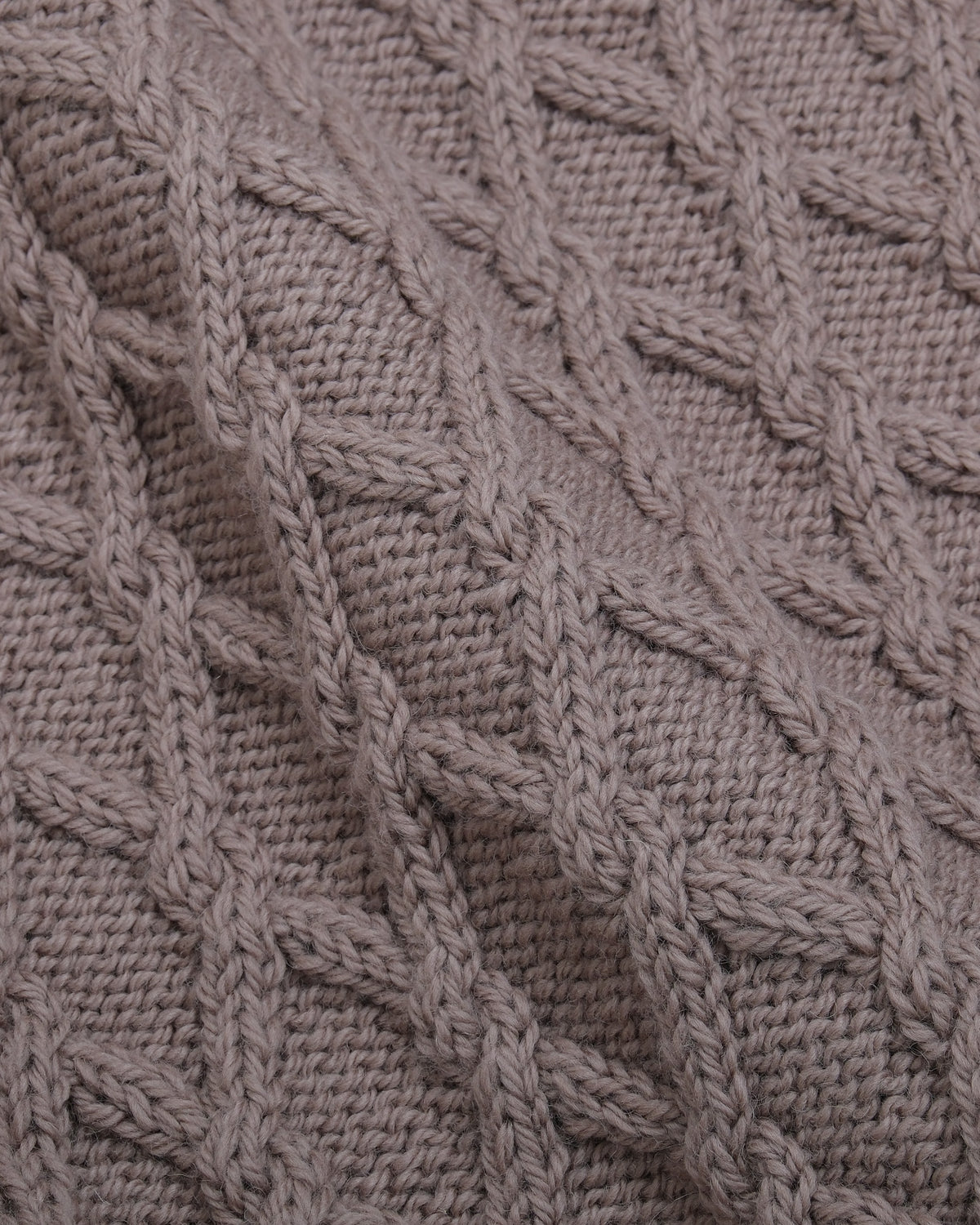 Detail of the dense hand-knitted lambswool cable structure on the Cannon Hand-Knitted Mariner by Rubato.