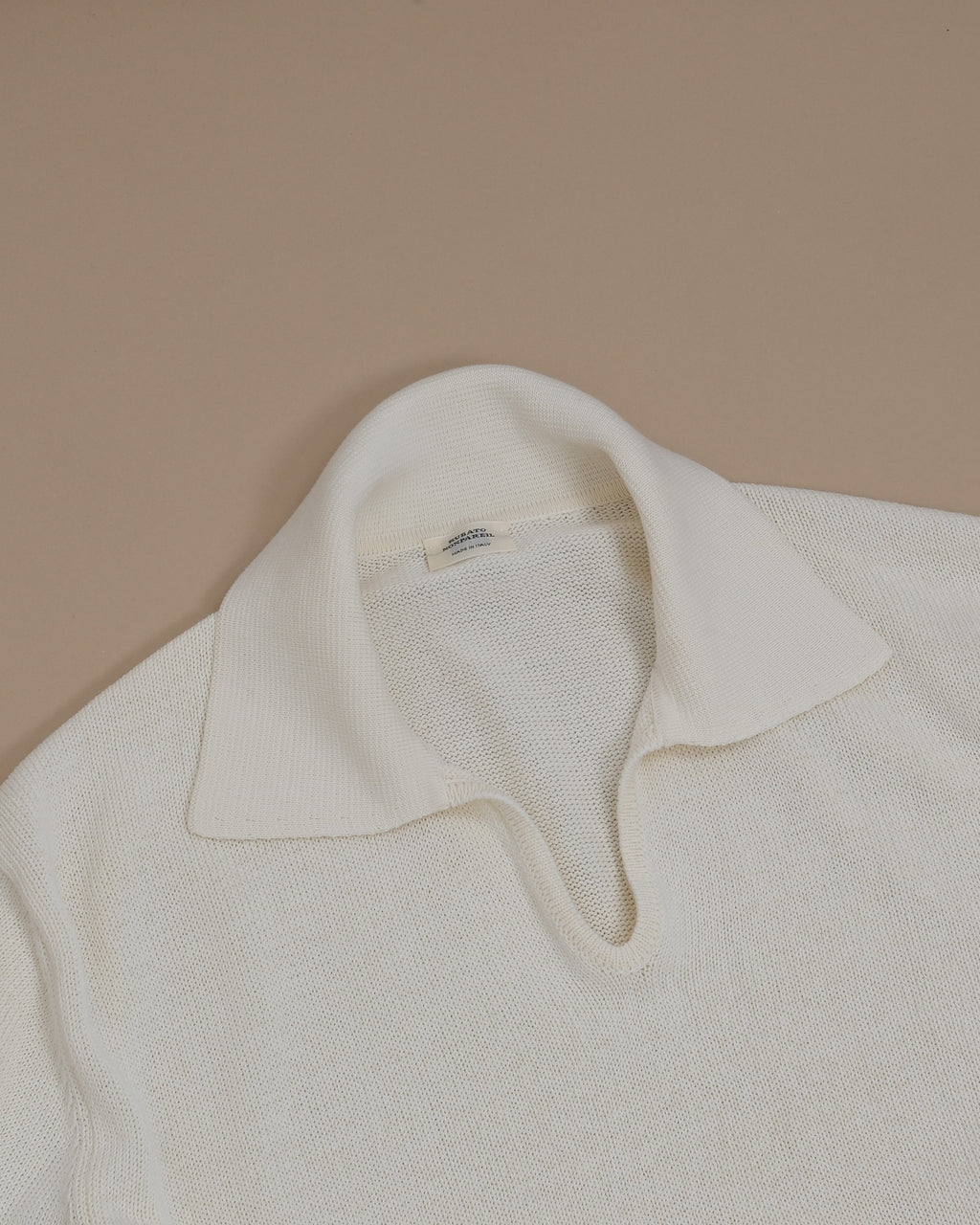 Detail of the generous collar and ribbed open polo on the Cream Nonpareil Fairbanks Polo by Rubato