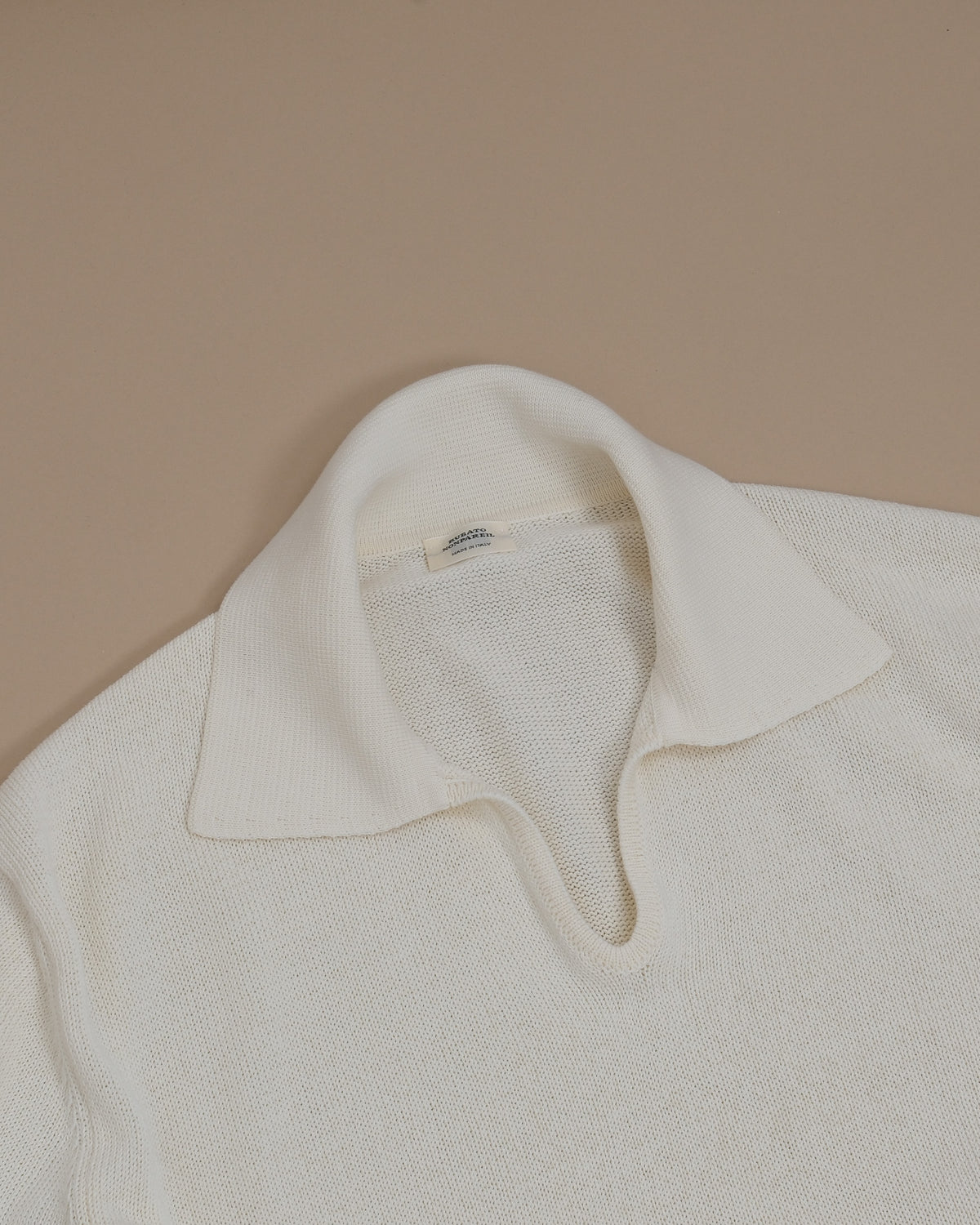 Detail of the generous collar and ribbed open polo on the Cream Nonpareil Fairbanks Polo by Rubato