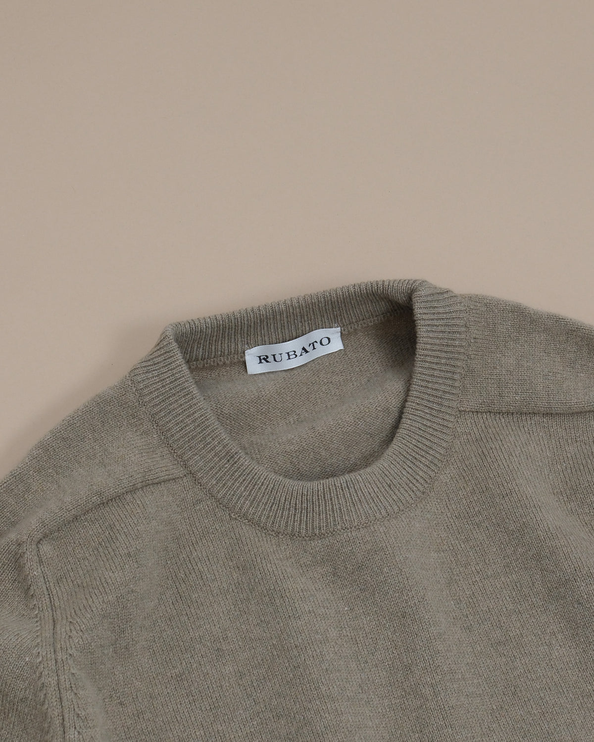 Detail of the ribbed crewneck and saddle shoulder on the Gravel Lambswool Standard Crewneck by Rubato
