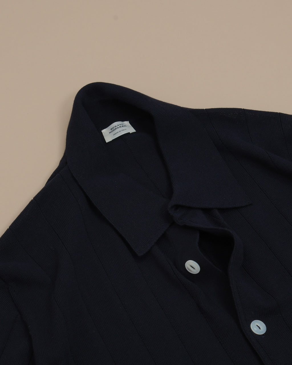 Detail of button placket and collar on rubato Navy Nonpareil Collo Americano Short-Sleeve Polo by Rubato