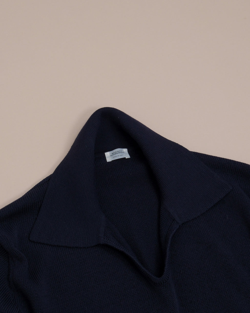 Detail on the open collar construction and collar on the Navy Nonpareil Fairbanks Polo by Rubato