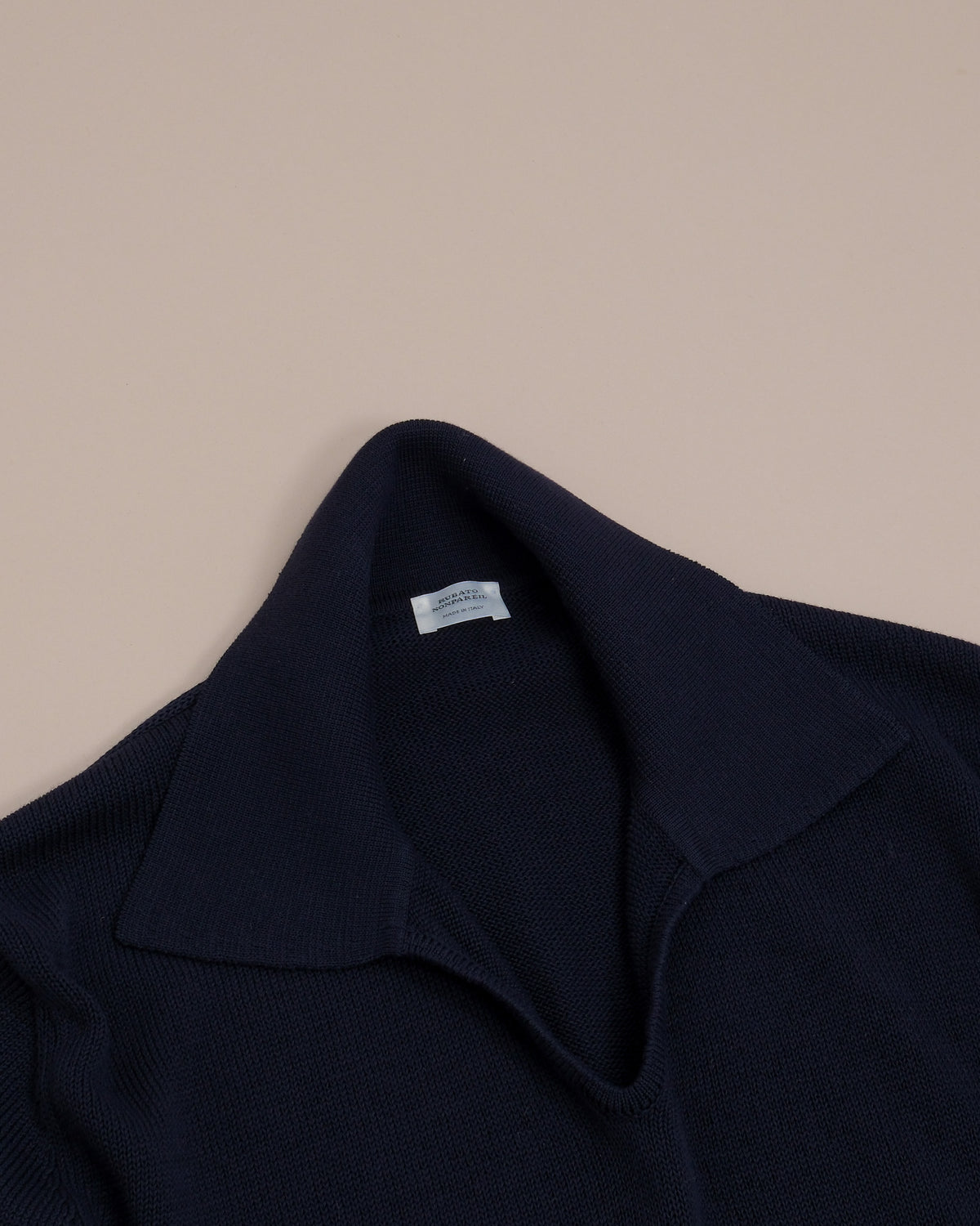 Detail on the open collar construction and collar on the Navy Nonpareil Fairbanks Polo by Rubato