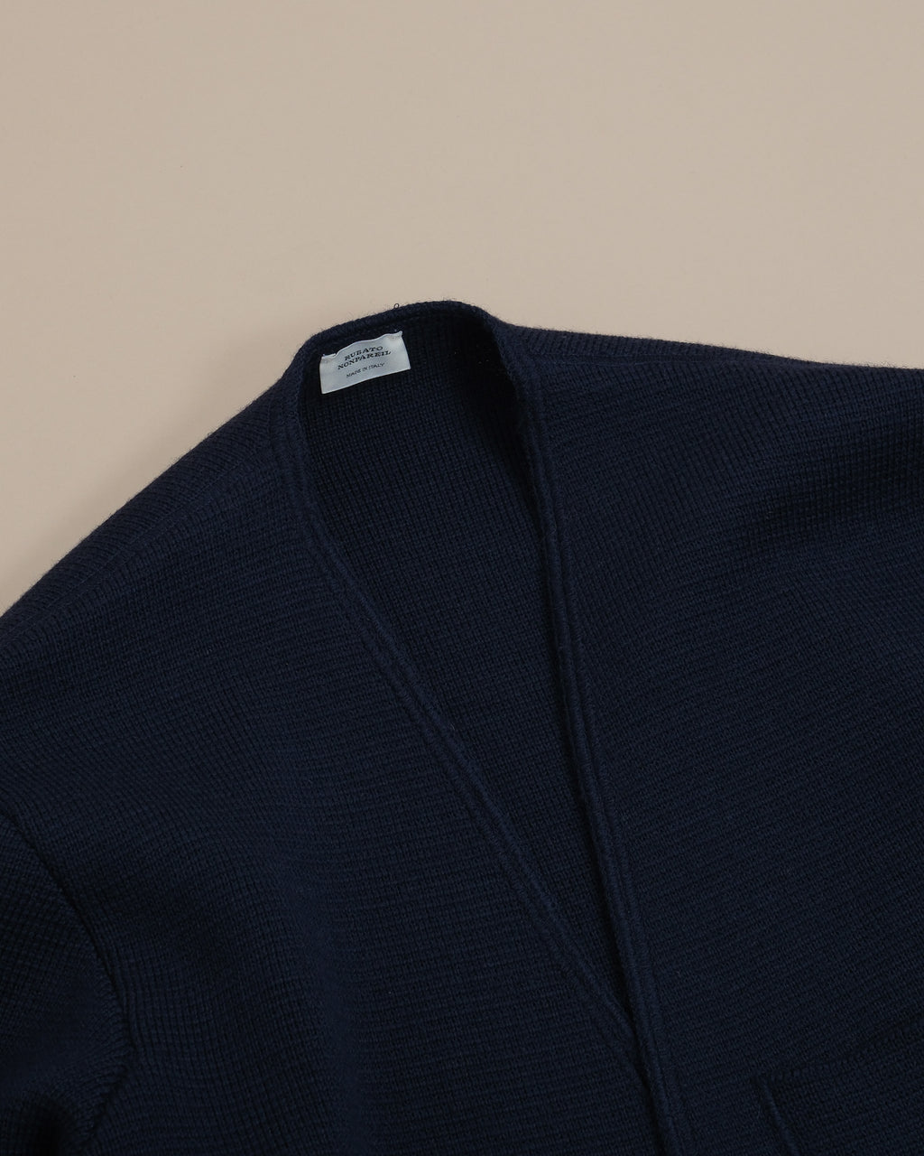 Detail of the Milano knit and ribbed neckline of the Navy Nonpareil Somerset Jacket by Rubato.
