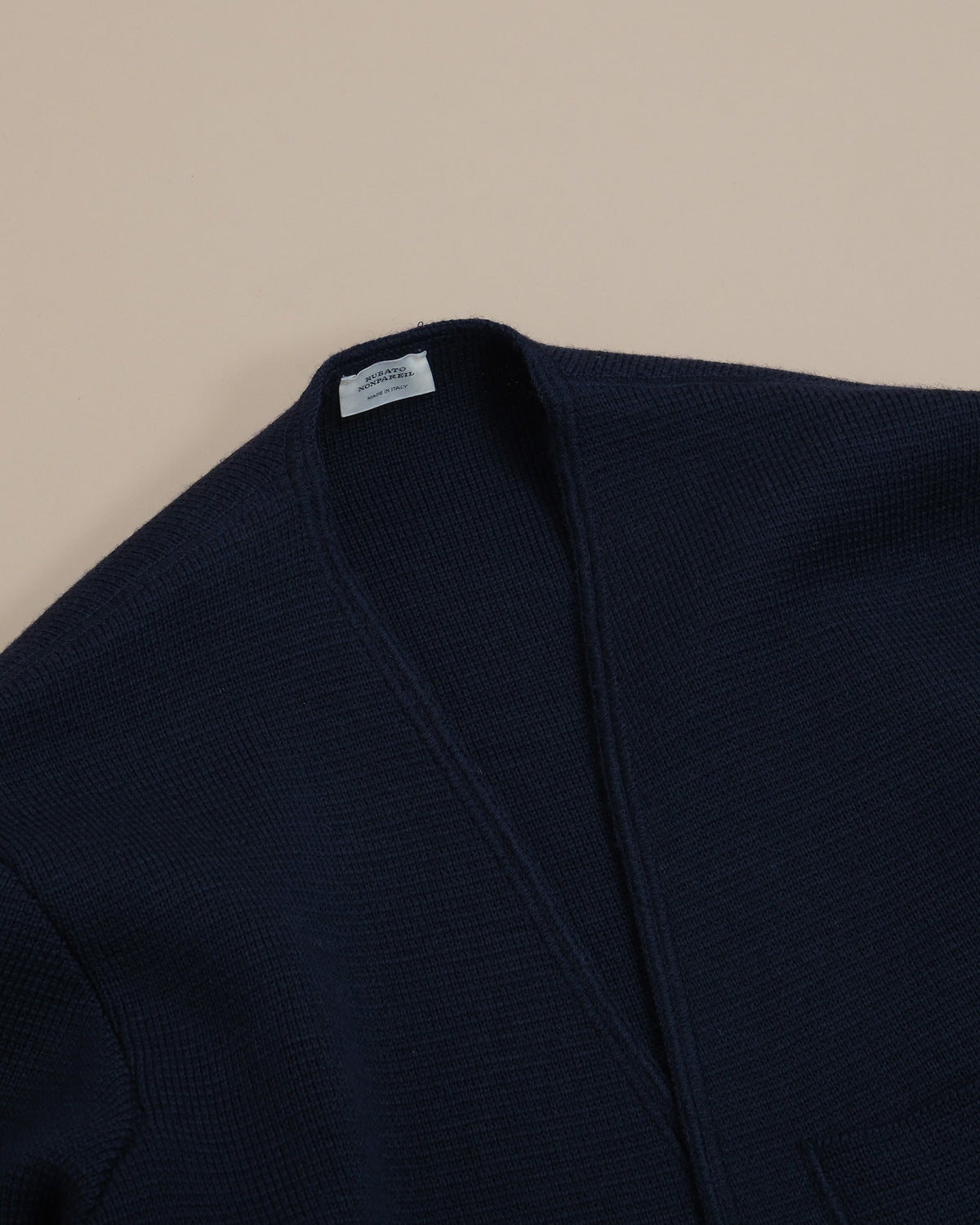 Detail of the Milano knit and ribbed neckline of the Navy Nonpareil Somerset Jacket by Rubato.