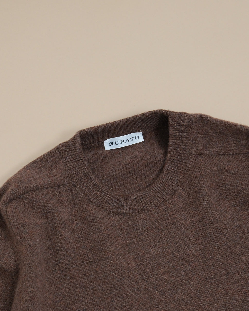 Detail of the ribbed crewneck and saddle shoulder on the Tobacco Lambswool Standard Crewneck by Rubato