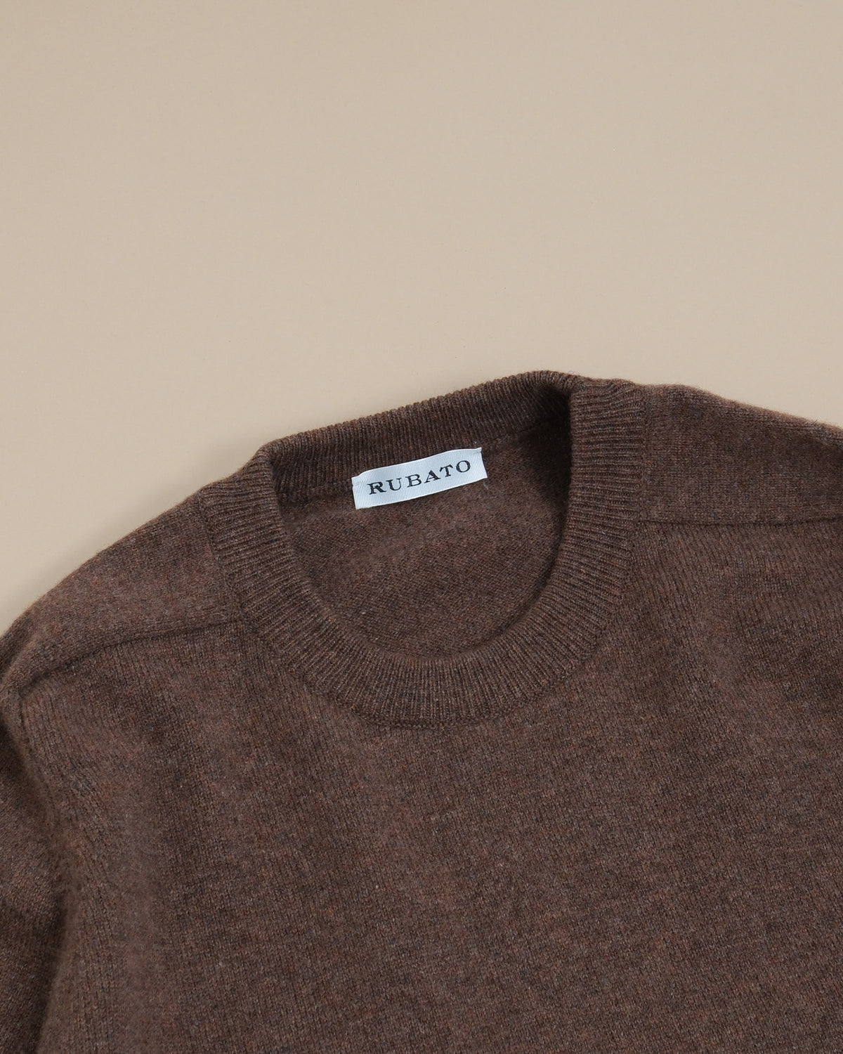 Detail of the ribbed crewneck and saddle shoulder on the Tobacco Lambswool Standard Crewneck by Rubato