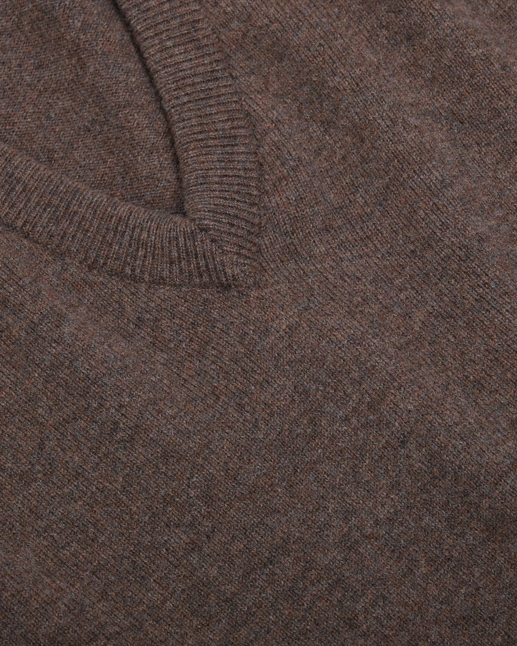 Detail of the ribbed deep V-neck on the Tobacco Lambswool Standard V-Neck by Rubato