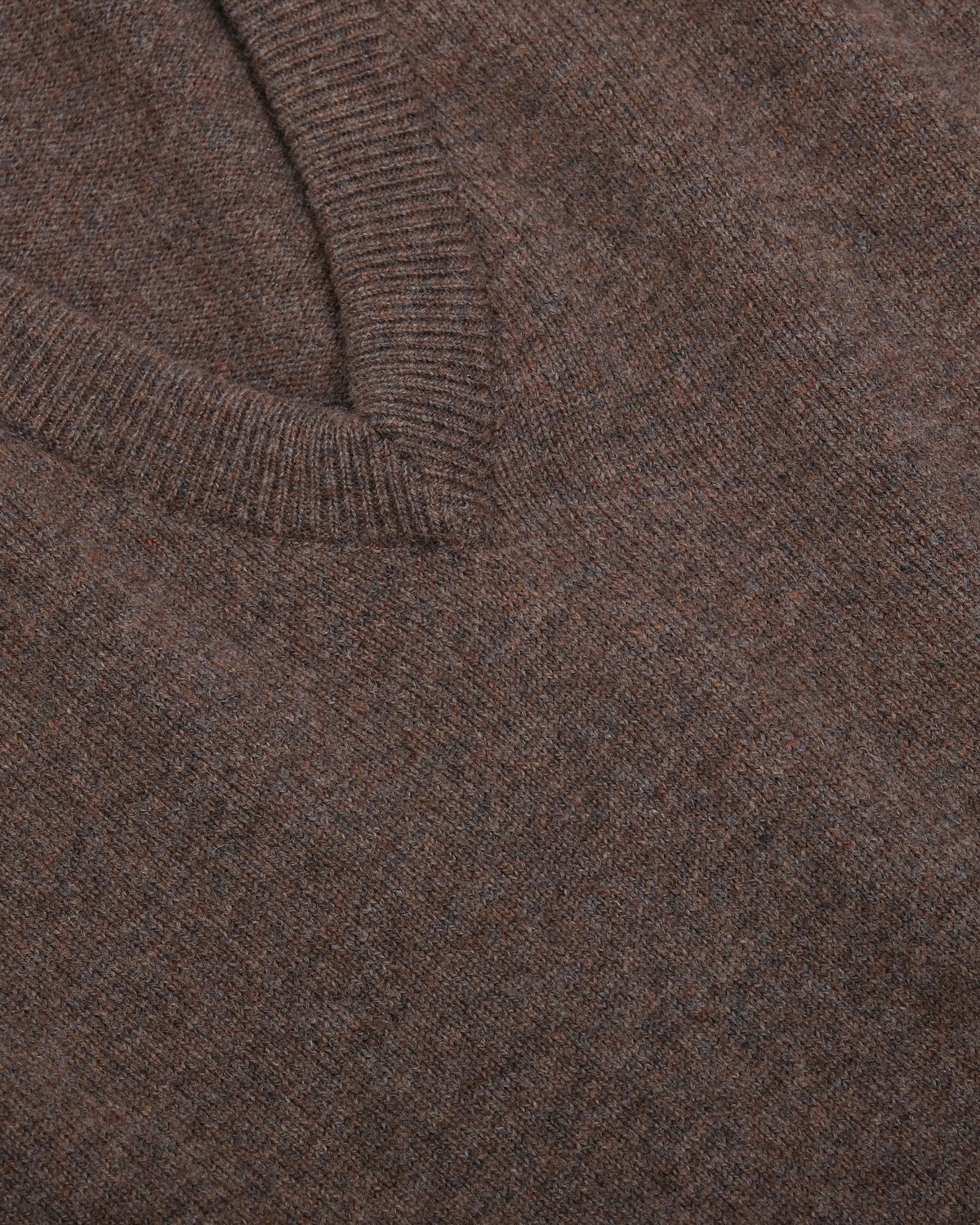 Detail of the ribbed deep V-neck on the Tobacco Lambswool Standard V-Neck by Rubato